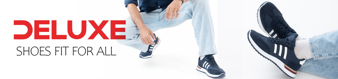 Lifestyle image of a model wearing Deluxe navy blue lace-up casual sneakers with white stripe design, cushioned sole, and lightweight comfort for everyday wear
